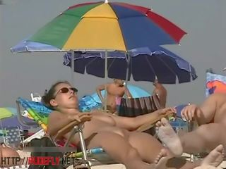 A clean-cut chick in a nude beach spy cam video